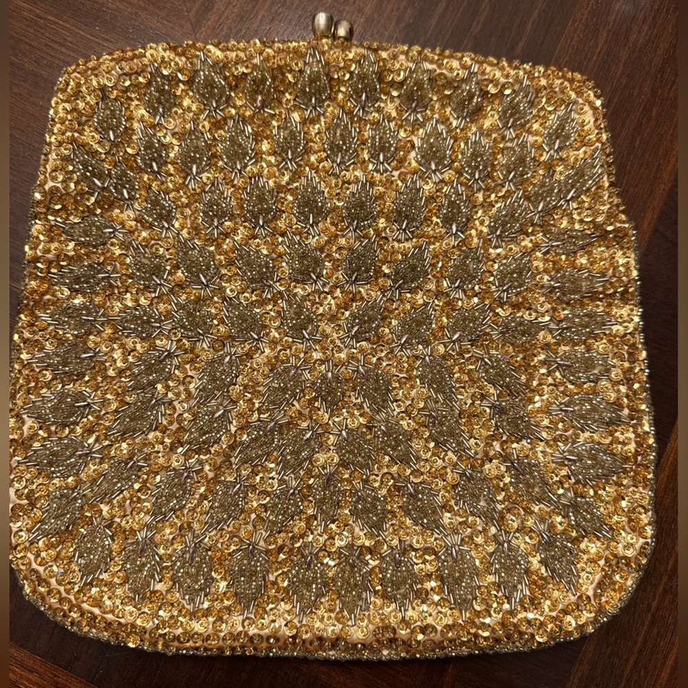 Used small clutch bag/ purse in gold color. Snap top. Made in Hong Kong.